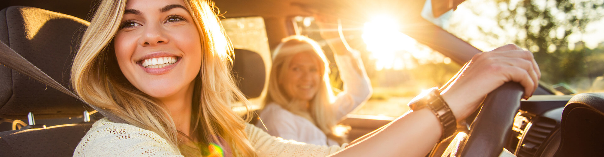 Young woman is driving a car