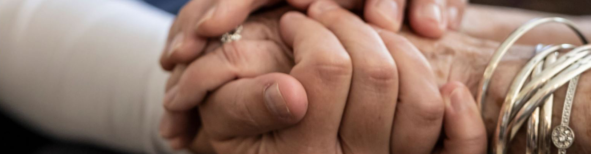 Nurse holding senior patient hands