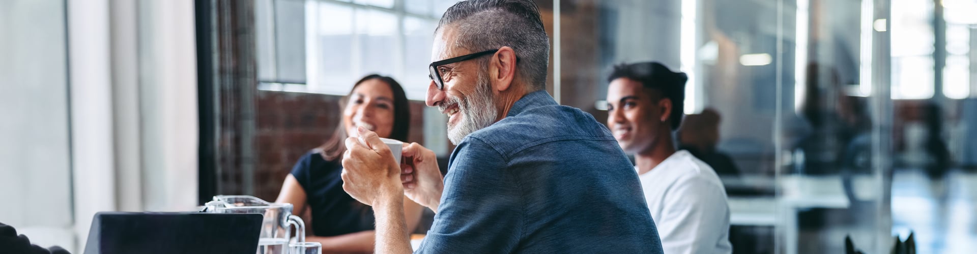 People sitting in a meeting smiling