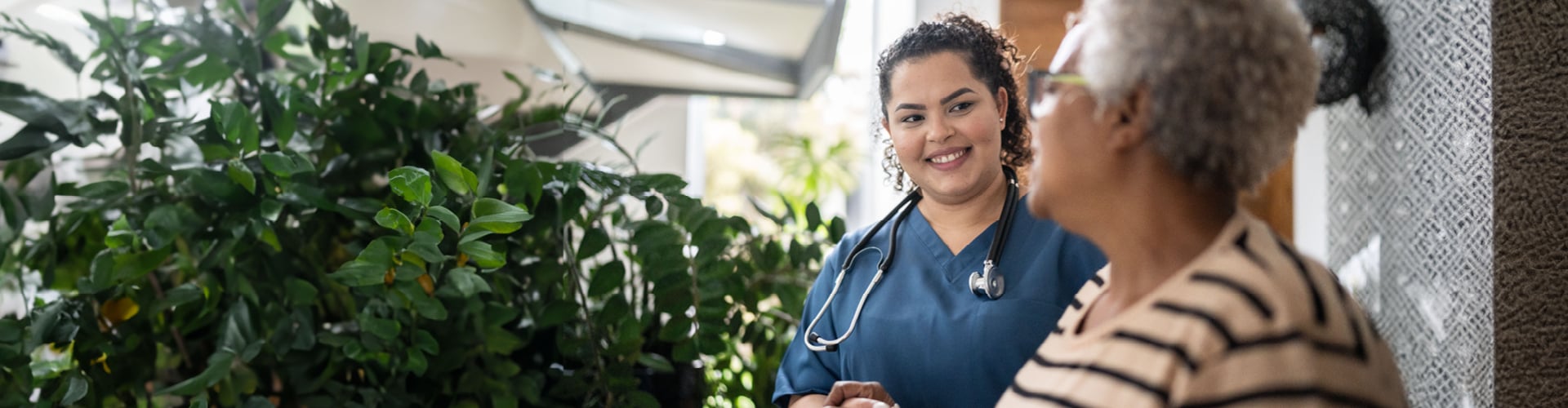 Nurse chatting with older woman